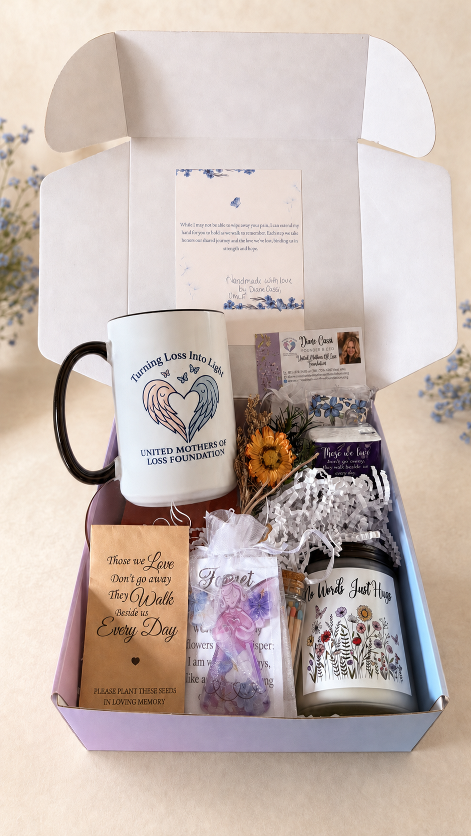 United Mothers of Loss Foundation Remembrance Care Package No. 1 with a mug, candle, flower, seed packet, cards, and comforting keepsakes